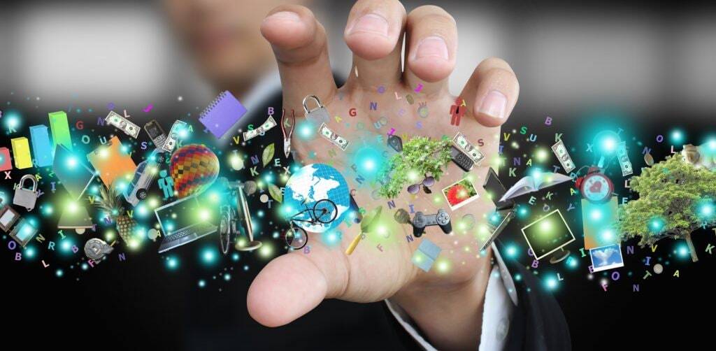 Business person's hand reaching toward a collage of various illustrations meant to signify various types of data