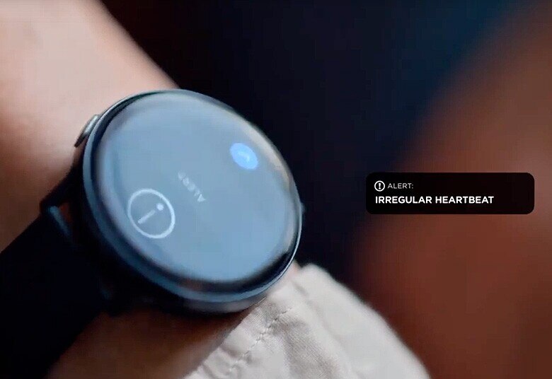 Person's wrist with watch showing an irregular heartbeat alert