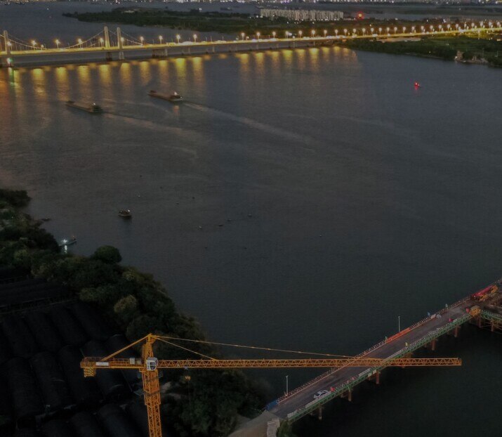 Aerial view of a construction site with a bridge over the river