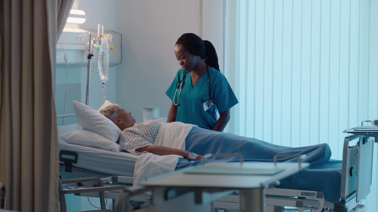 Doctor or Nurse at patient bedside