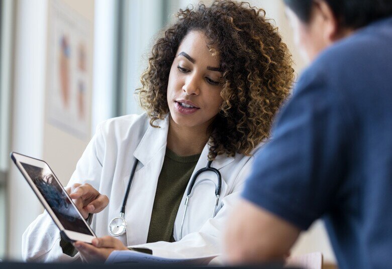 Physician pointing to tablet screen