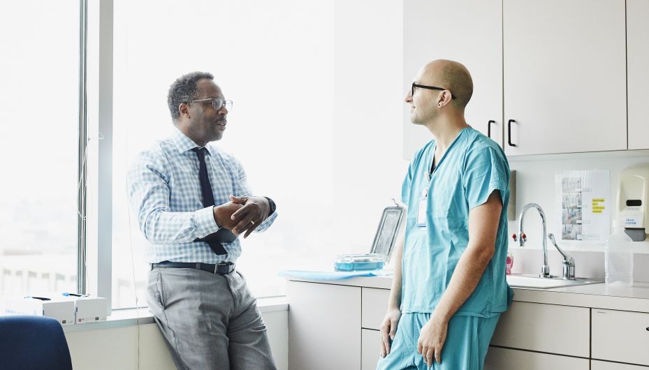 medical staff having a relaxed conversation in an exam room