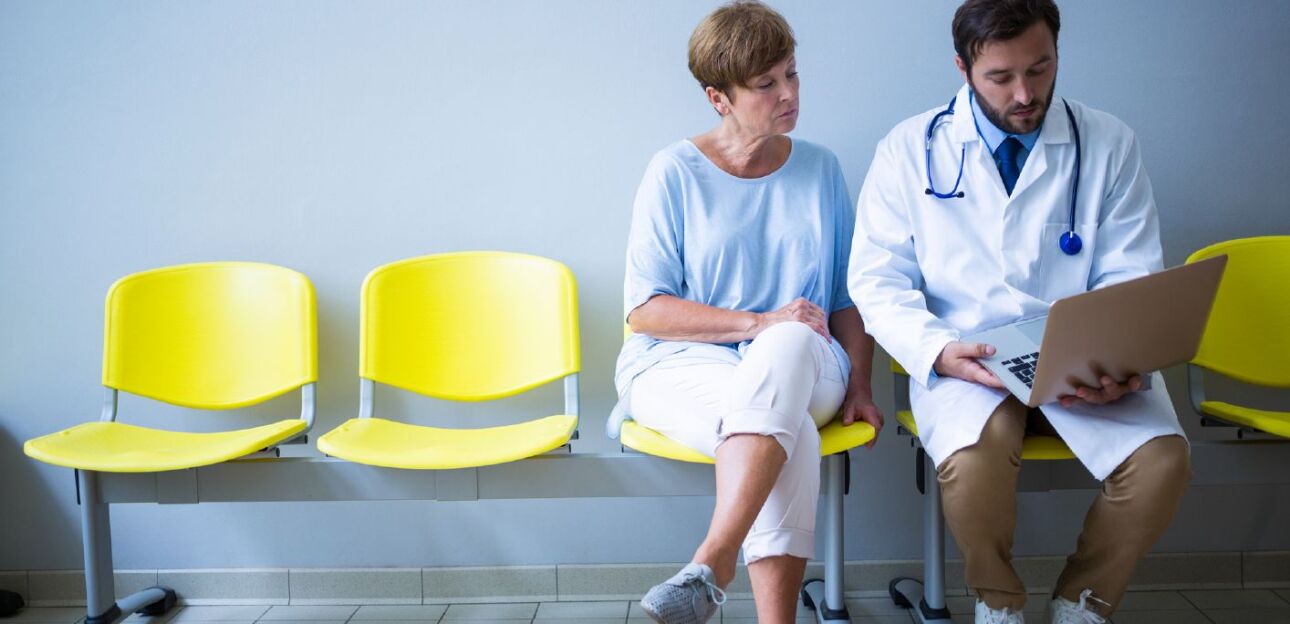 Doctor and patient seated in hallway