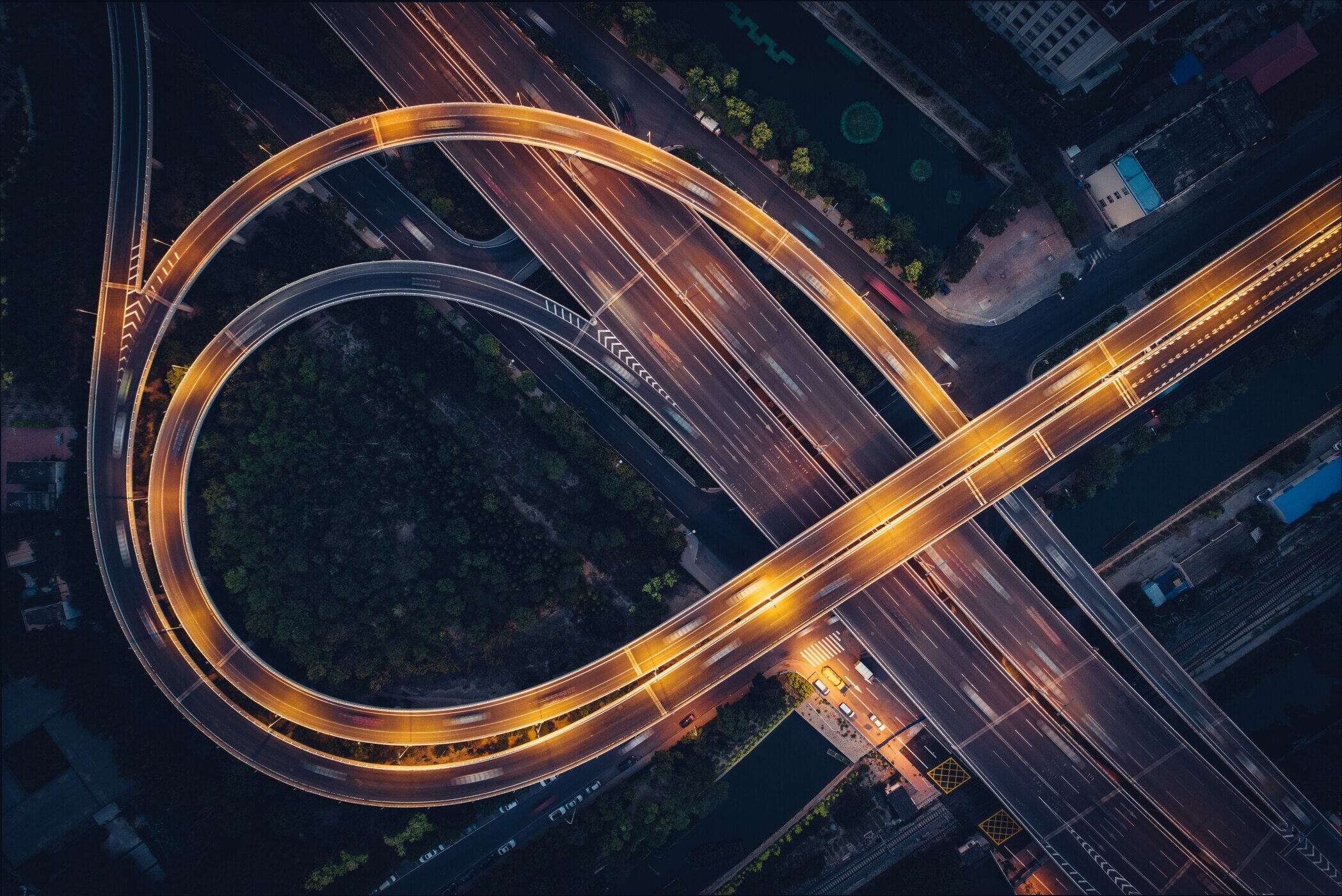overhead view of highway ramp traffic at night