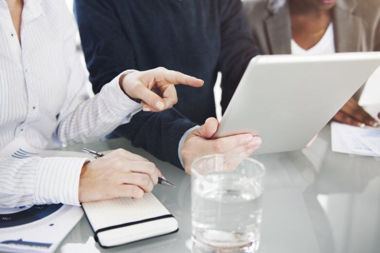 group of business people looking at a tablet