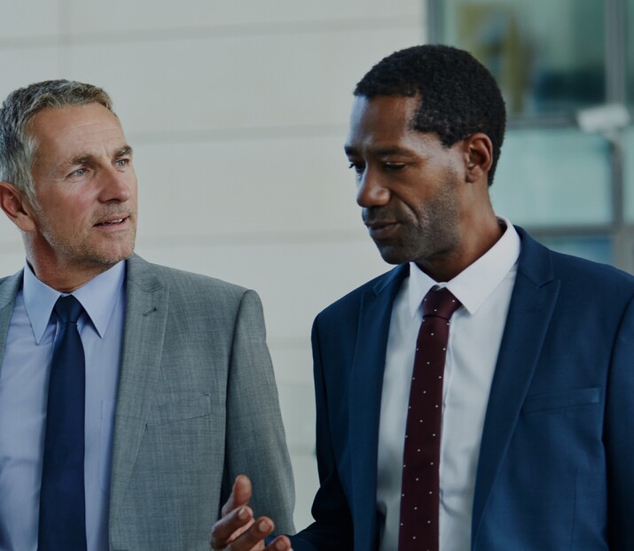 Two businessmen walking and talking