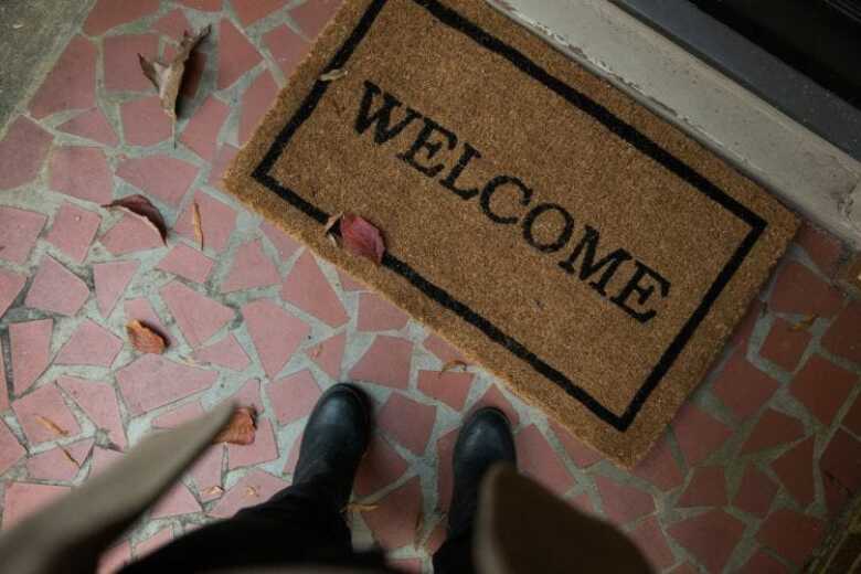 looking down at a welcome mat at the front door of a home