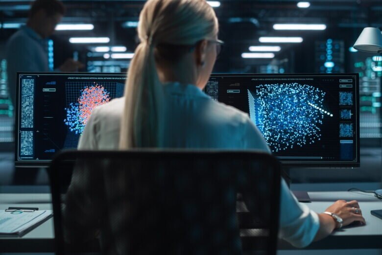 Digital computer screen with women in front of monitor