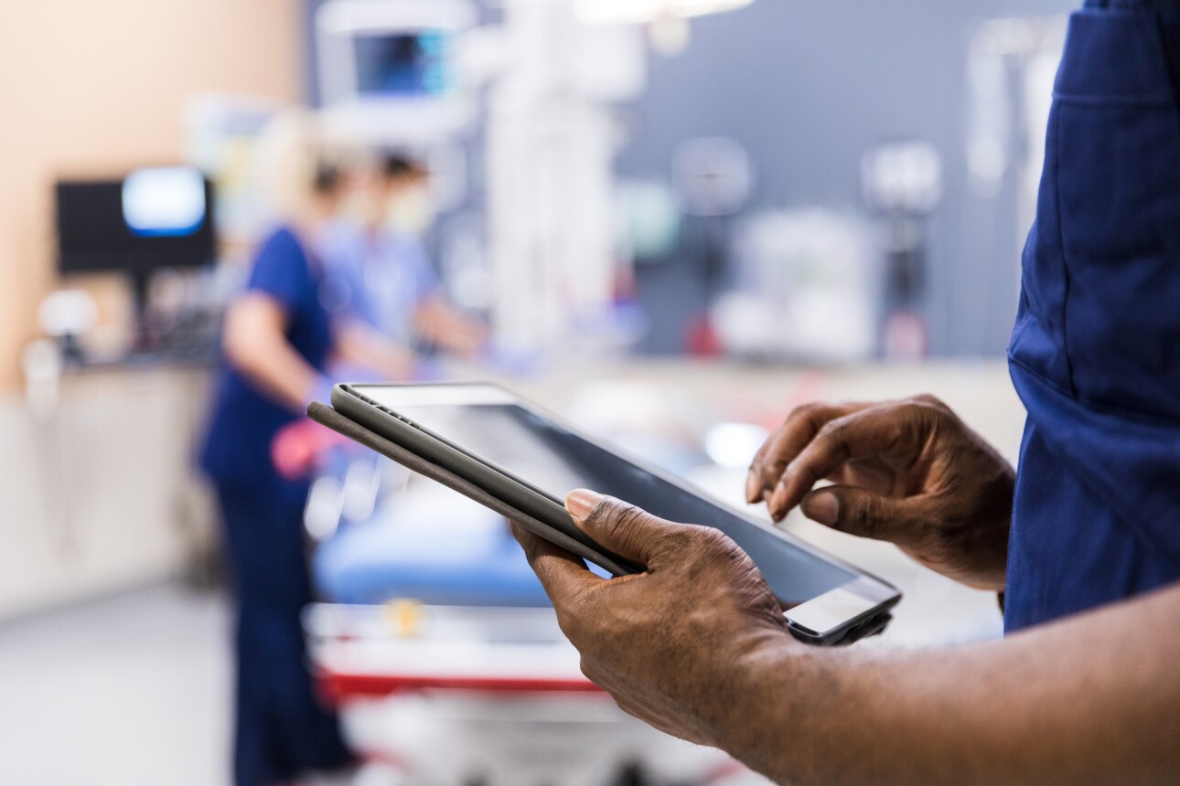 medical staff using digital tablet to review medical chart