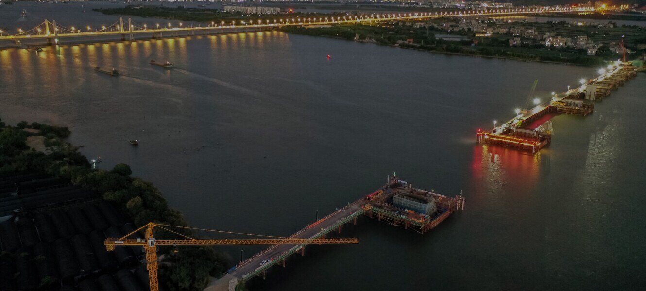 Aerial view of a construction site with a bridge over the river