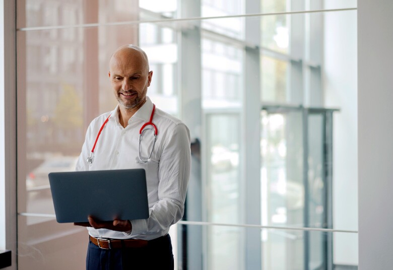 male doctor looking at his laptop