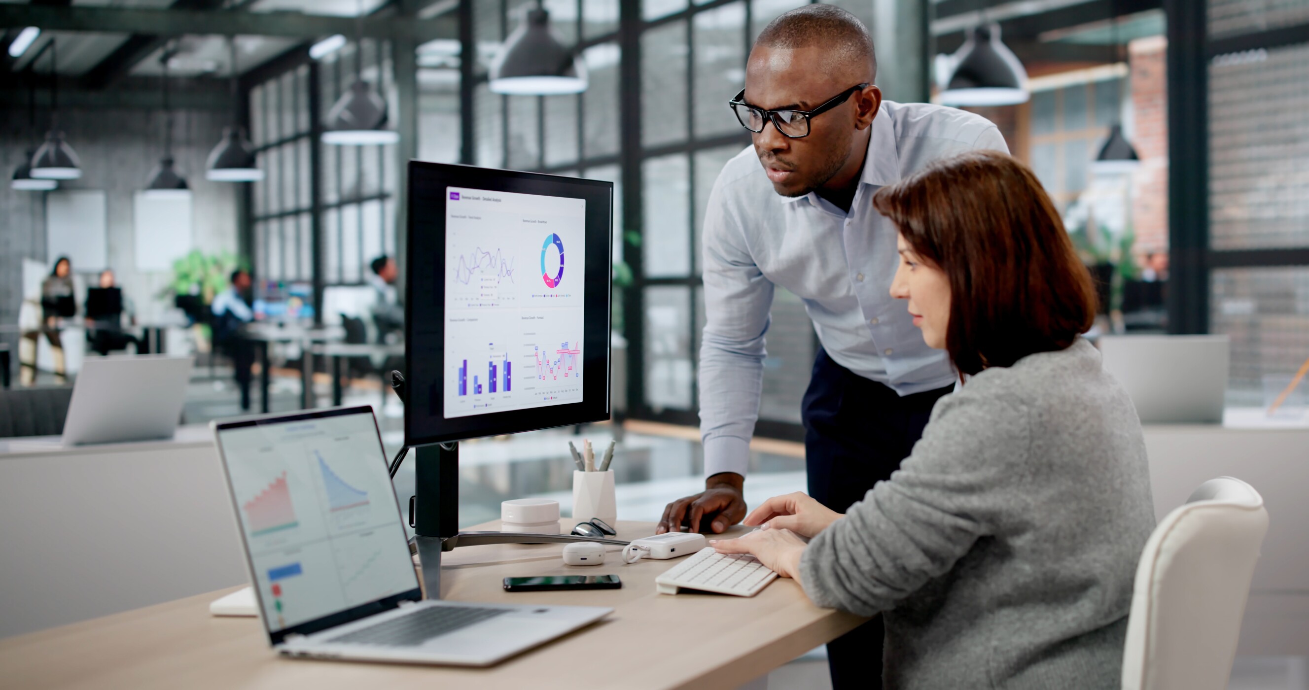 Business Analyst And Marketing Manager Analyze Data On Computer Dashboards